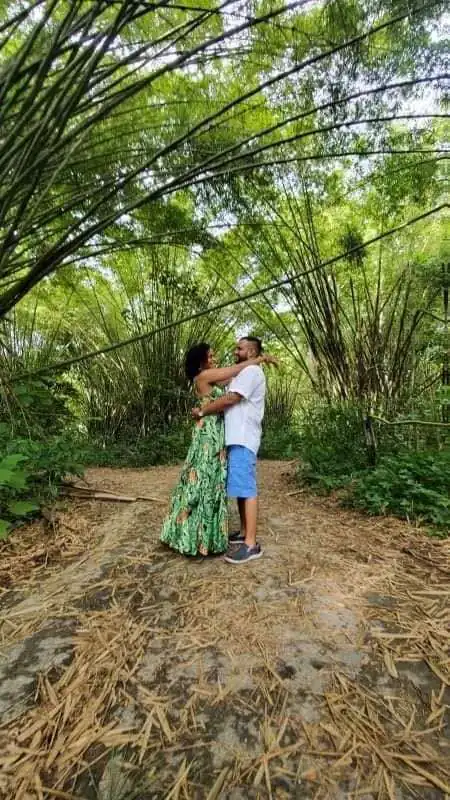 Couple embracing under bamboo arches