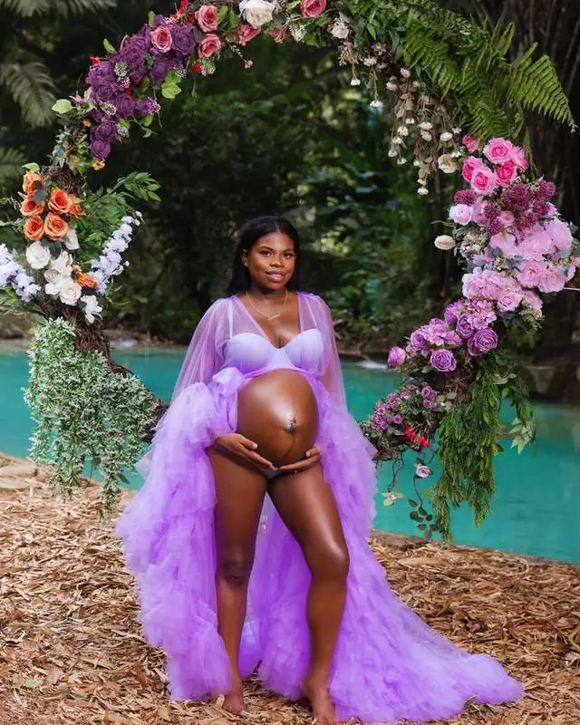 Maternity photoshoot with a floral arch by the pool